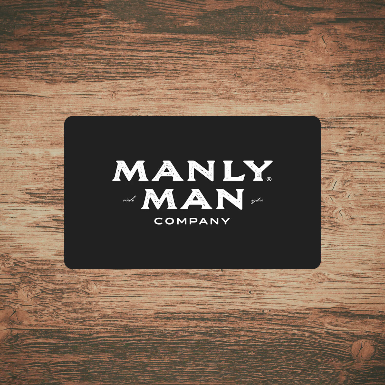 Manly Man Co. eGift Card on wood background – perfect Father's Day gift option.