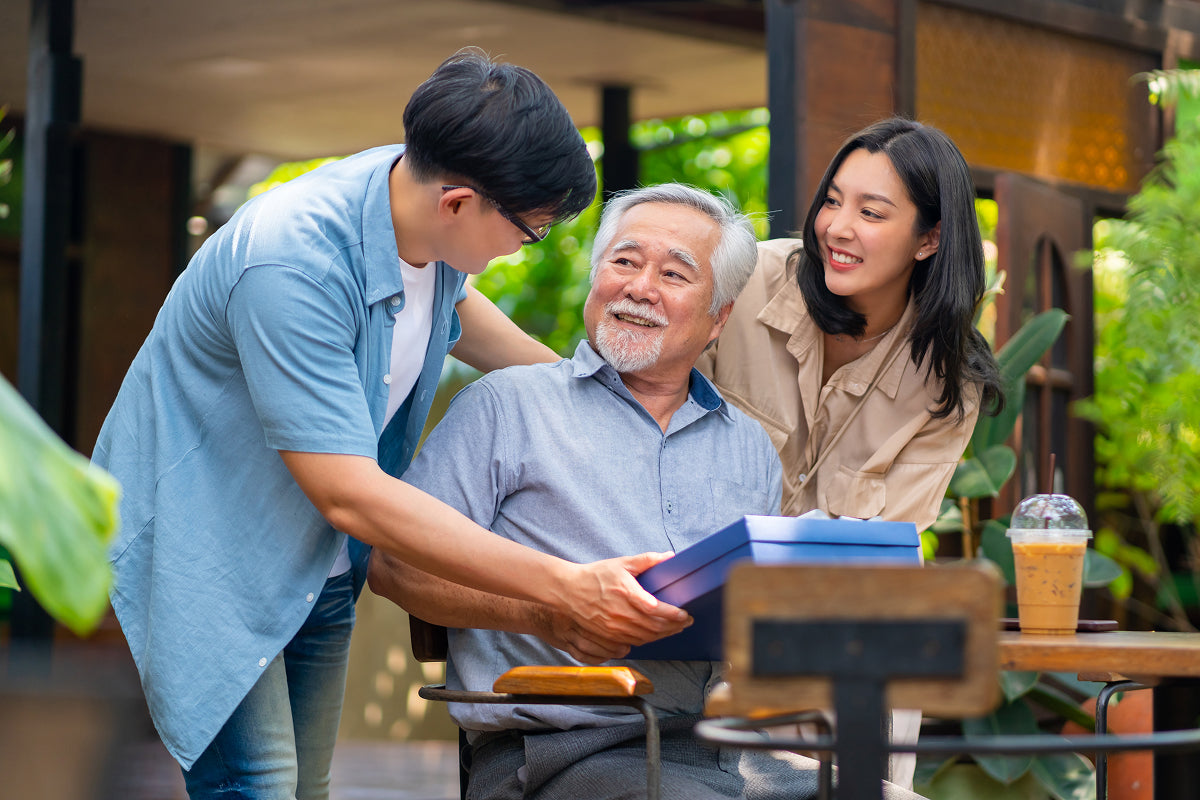 Boyfriend introducing girlfriend to his dad over coffee—perfect moment for gifting something bold like The Meat Card™ or Best Jerky Gift Box.