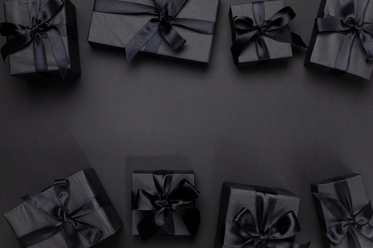Minimalist black gift boxes on dark background—ideal for meaningful, faith-driven wedding gifts