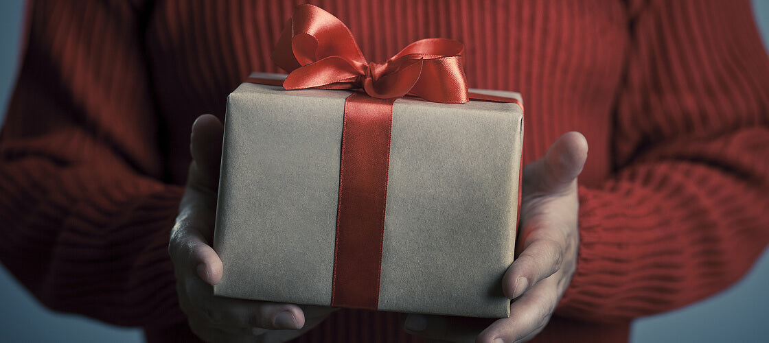 Unique company gifts for employees including bacon strip bouquets, ammo can snack boxes, and whiskey caramel decanters perfect for team appreciation.