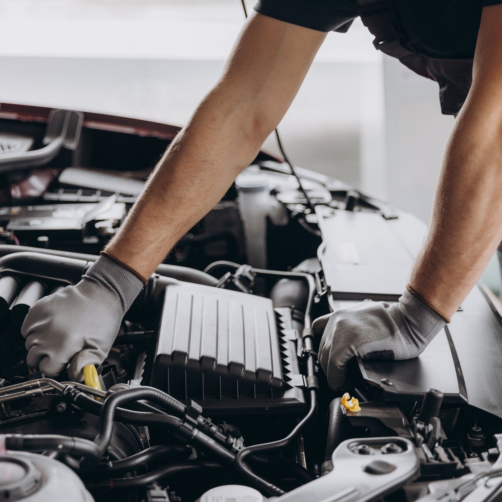 Best gifts for automotive technicians – mechanic working under the hood.
