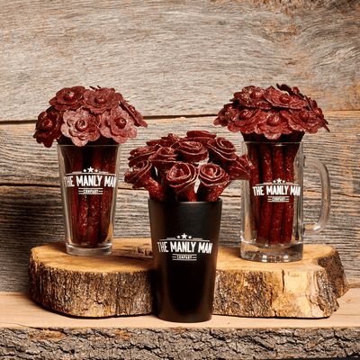 Three different vases of Valentine's Day flower bouquets in front of wood background